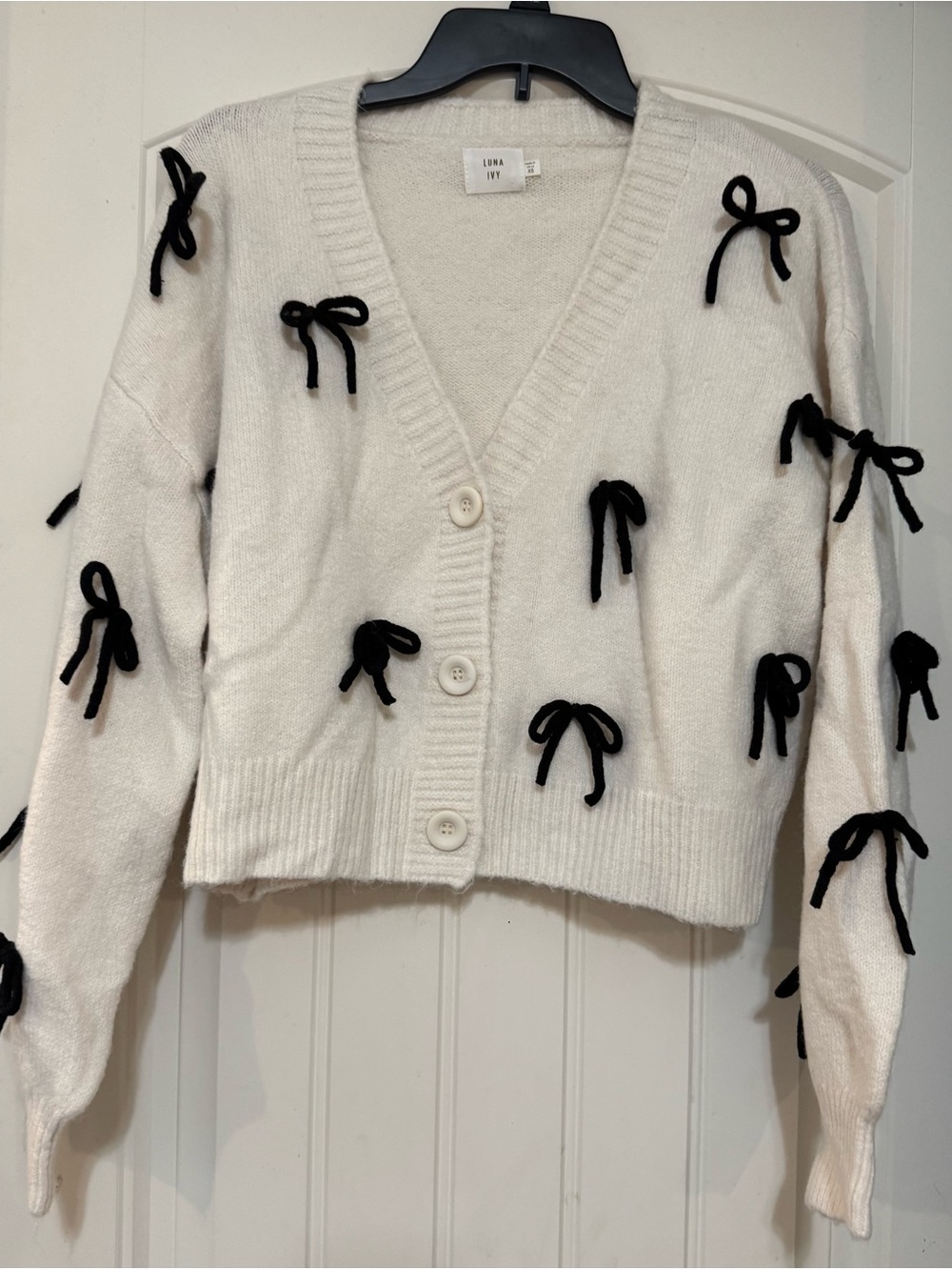Luna Ivy Cream V-Neck Cardigan with Black Bow Details